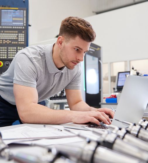 Engineer using CAD software in a factory